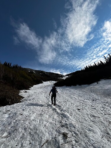 Ascending the snow filled gully. Peak is directly above to the left