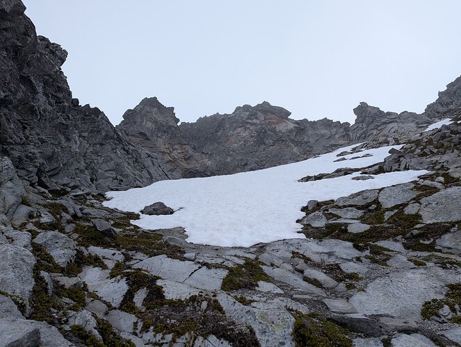 Looking up towards the upper wide "chimney" crux above the snow